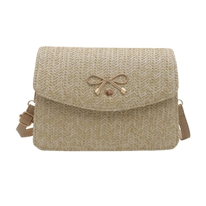 Chic beige woven crossbody bag with a golden bow buckle and adjustable strap
