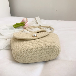Handwoven straw shoulder bag with large pearl clasp and strap for summer beach vacations
