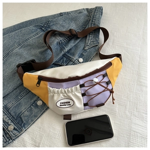 Détail du sac bandoulière color-block avec poche à cordon et téléphone pour la taille