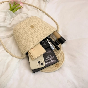 Handmade woven shoulder bag in beige with interior storage view and flap closure
