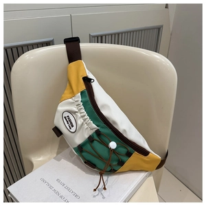 Détail du sac de poitrine en toile tricolore avec panneaux jaune, blanc et vert