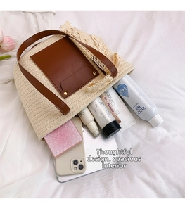 Straw tote bag detail showing large capacity with tablet and makeup on white cloth