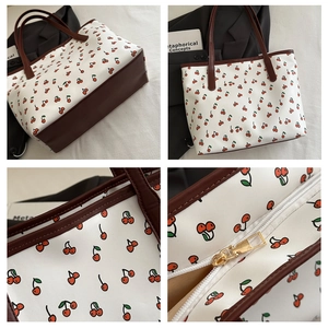 Detailed views of cherry print canvas tote bag with brown leather trim and gold zipper