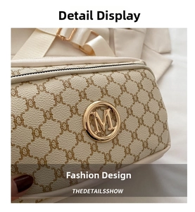Close-up of cream vintage pattern bag with golden M logo and metal hardware detail