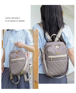 Detail view of quilted lavender backpack with gold heart rivets and woven straps