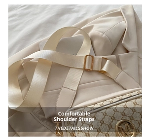 Detail of retro floral pattern handbag with wide fabric strap and golden metal M logo