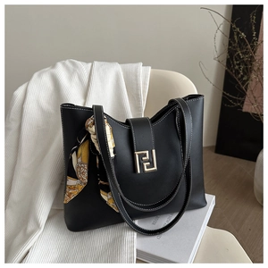 Detail of black tote bag with white contrast stitching, gold F buckle and silk scarf handle
