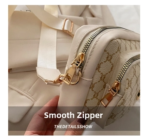 Detail shot of the vintage crossbody bag showing side stitching and gold metal zipper