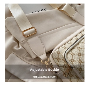 Detail of adjustable nylon strap and metal buckle on cream crossbody bag with floral print