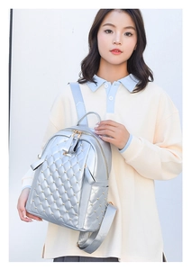 Silver quilted backpack detail with gold studs and textured faux leather finish