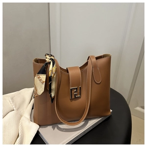 Close-up of brown leather tote bag with F-motif metal buckle and decorative silk scarf