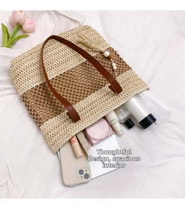 Detail of color-block straw tote showing spacious interior for essentials and makeup