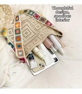 Macro detail of beige crochet tote bag showing spacious interior and floral knit strap