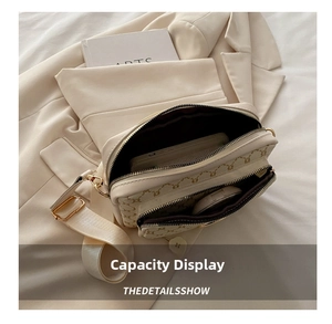 Internal view showing dual zipper compartments of the vintage crossbody camera bag