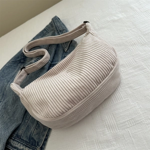 Minimalist cream white corduroy dumpling crossbody bag with adjustable wide shoulder strap
