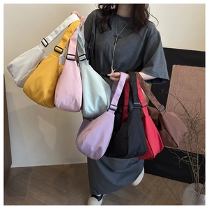 Detailed display of large capacity half-moon shoulder bags in eight assorted vibrant colors
