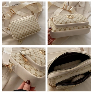 Detail view of vintage beige crossbody bag with gold metal logo and wide nylon strap