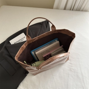 Brown metallic tote bag with large capacity showing books and tablet inside for work