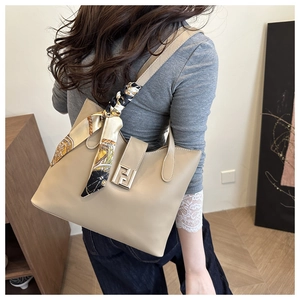 Detail of beige leather handbag with printed silk scarf and metallic FF buckle logo