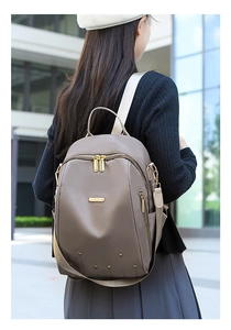 Sac à dos marron en tissu Oxford avec fermetures dorées et détails d'étoiles