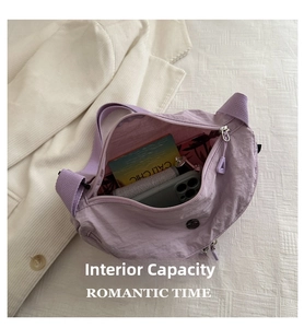 Detail shot of the spacious interior of this light purple nylon crescent crossbody bag