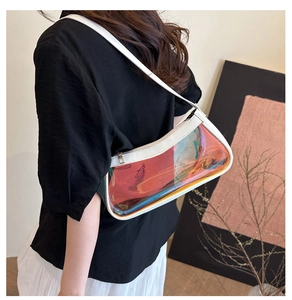 Chic iridescent PVC baguette bag with white leather trim shown on shoulder of a model