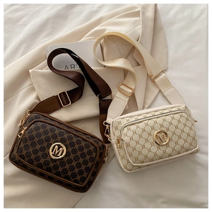 Detail of vintage pattern crossbody bags with gold M logo and adjustable wide straps