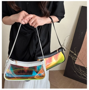 Detailed view of iridescent PVC shoulder bag with sleek black trim and rainbow finish