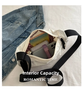 Spacious interior of white pleated crossbody bag showing phone and daily essentials