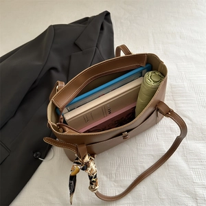 Brown leather large tote bag with silk scarf showing spacious interior for work essentials