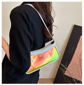 Close-up of holographic transparent shoulder bag with blue trim and sleek zipper detail