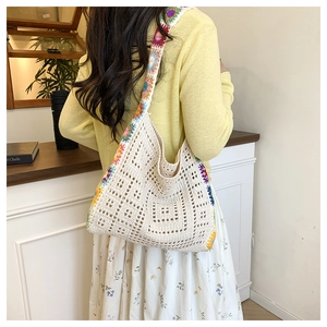 Close-up of bohemian crochet tote bag with colorful knit patterns and hollow-out texture