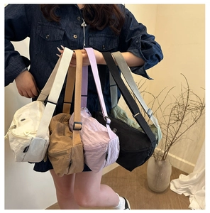 Detail of minimalist nylon crescent bags in five colors with wide adjustable straps