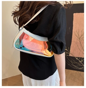 Detailed shot of transparent iridescent PVC shoulder bag with white leather trim details