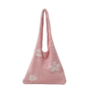 Pink crochet knit tote bag with white floral patterns and minimalist shoulder design