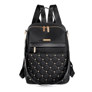 Quilted diamond lattice backpack with gold rivets and spacious casual travel design