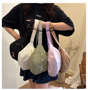 Detail of five-color nylon chest bags with ribbon embroidery and adjustable straps