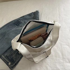 Large white canvas tote bag for women showing spacious interior and casual crossbody design