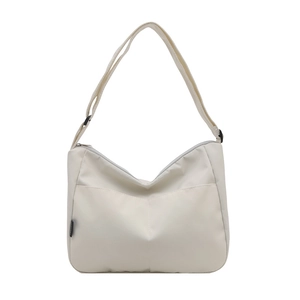 Minimalist off-white canvas tote bag with adjustable shoulder strap and spacious interior