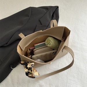 Large khaki tote bag with printed silk scarf showing spacious interior for daily essentials