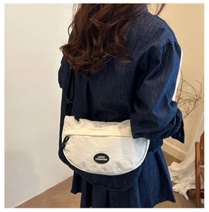 Detailed back view of a white nylon crescent crossbody bag with LUCKY FASHION label