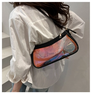Close-up of iridescent TPU cosmetic bag with black trim and gold zipper shown on shoulder