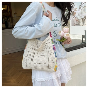 Detail of bohemian cream crochet shoulder bag with colorful floral knit edges