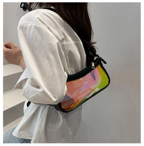 Detail of iridescent holographic shoulder bag with black leather trim and gold zipper