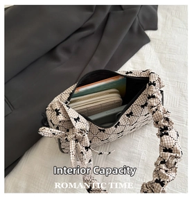 Spacious interior of plaid bow hobo bag showing capacity for wallet, phone and notebook