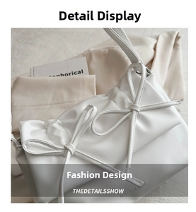 Detail of white PU tote bag featuring elegant pleated texture and leather bow accents