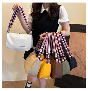 Detail of colorful striped woven straps on canvas shoulder bags in multiple colors