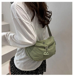 Detailed view of olive green waterproof nylon saddle bag with unique AA double zippers