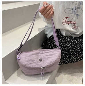 Detail of lavender nylon crescent bag showing textured fabric and adjustable shoulder strap