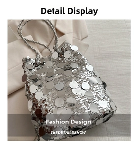 Close-up of silver sequin bucket bag featuring metallic discs and woven chain handle